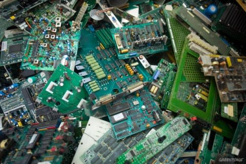 Discarded "mother boards" from old computers wait to be processed and stripped of the metal they contain at a junk yard in Guiyu. Much of modern electronic equipment contains toxic ingredients and as much as 4,000 tonnes of toxic e-waste is discarded every hour. Vast amounts are routinely and often illegally shipped as waste from Europe, USA and Japan to countries in Asia as it is easier and cheaper to dump the problem on poorer countries with lower environmental standards. Workers involved in dismantling e-waste are exposed to serious, environmental problems, danger and health hazards. © Natalie Behring/Greenpeace EDITORIAL USE ONLY.  NO ARCHIVING. NO RESALE. NO AFTER MARKET OR THIRD PARTY SALES. OK FOR ONLINE REPRO.