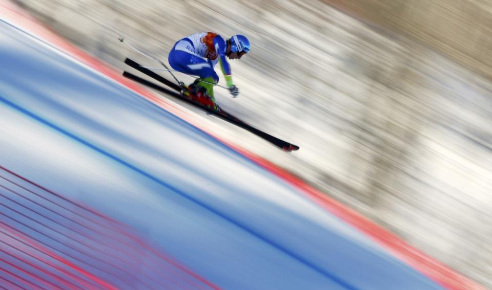Slovenia's Klemen Kosi speeds down the course during the downhill run of the men's alpine skiing super combined event at the 2014 Sochi Winter Olympics at the Rosa Khutor Alpine Center February 14, 2014. REUTERS/Dominic Ebenbichler