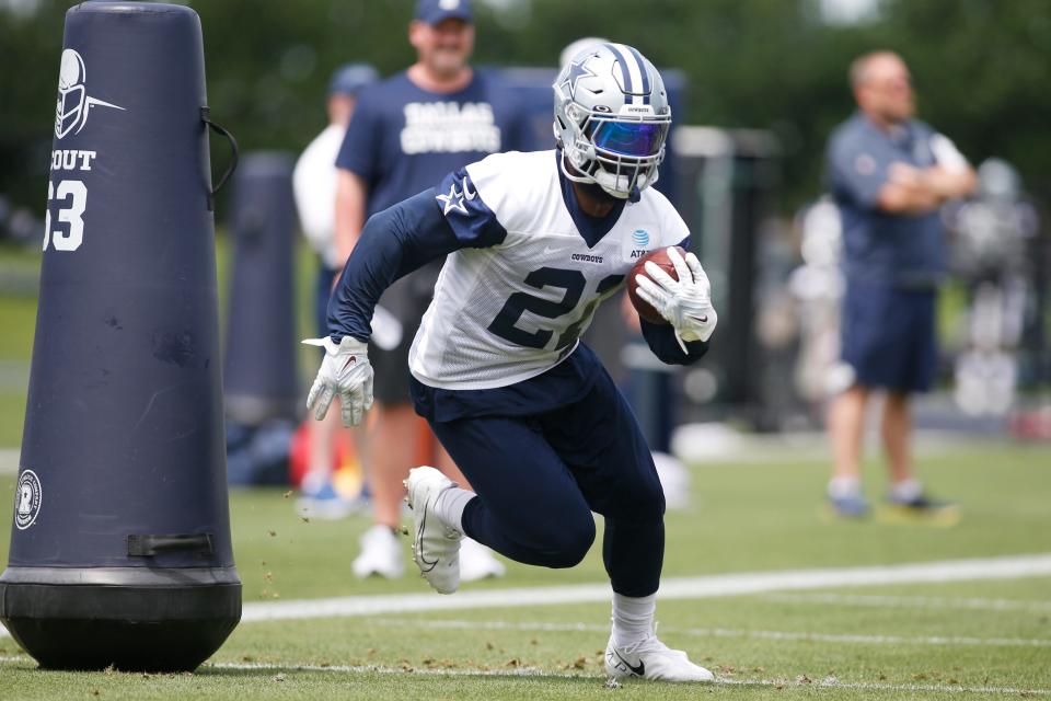 Dallas Cowboys running back Ezekiel Elliott (21) goes through drills during voluntary Organized Team Activities at the Ford Center at the Star Training Facility in Frisco, Texas.