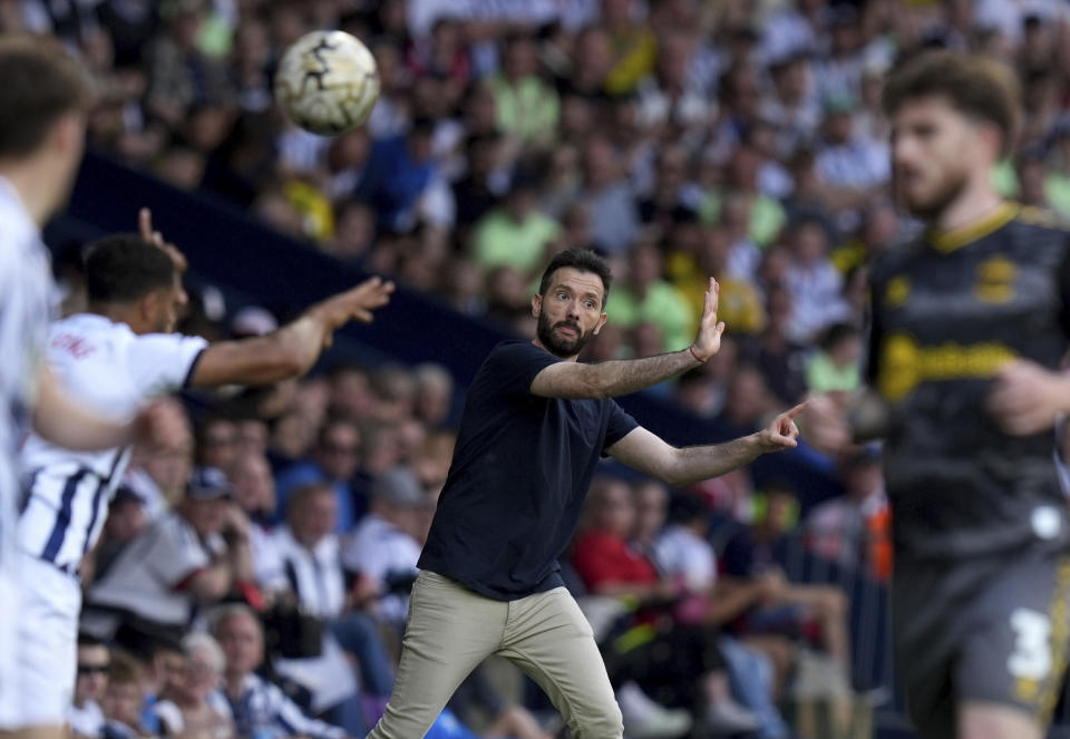 West Bromwich Albion manager Carlos Corberan , centre, gestures during the English Football League Championship play-off, semi-final, first leg soccer match between West Bromwich Albion and Southampton, at The Hawthorns, in West Bromwich, England, Sunday May 12, 2024. (Jacob King/PA via AP)