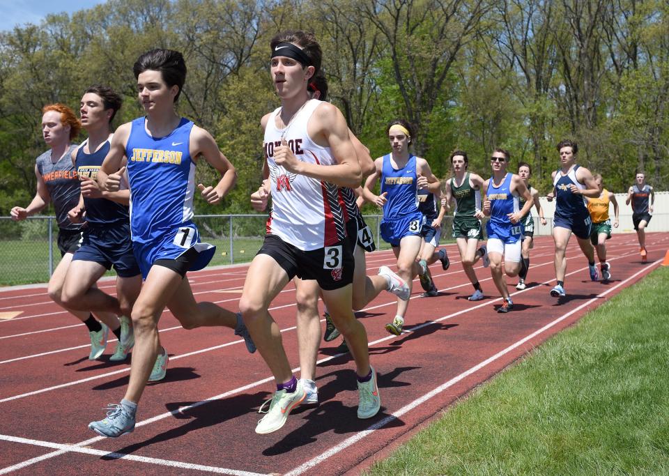 Carter McCalister of Monroe Jefferson in the pack with Jackson Ansel of Erie Mason and several others in the first lap of the 1600 meter run at the Mason Invitational Saturday.