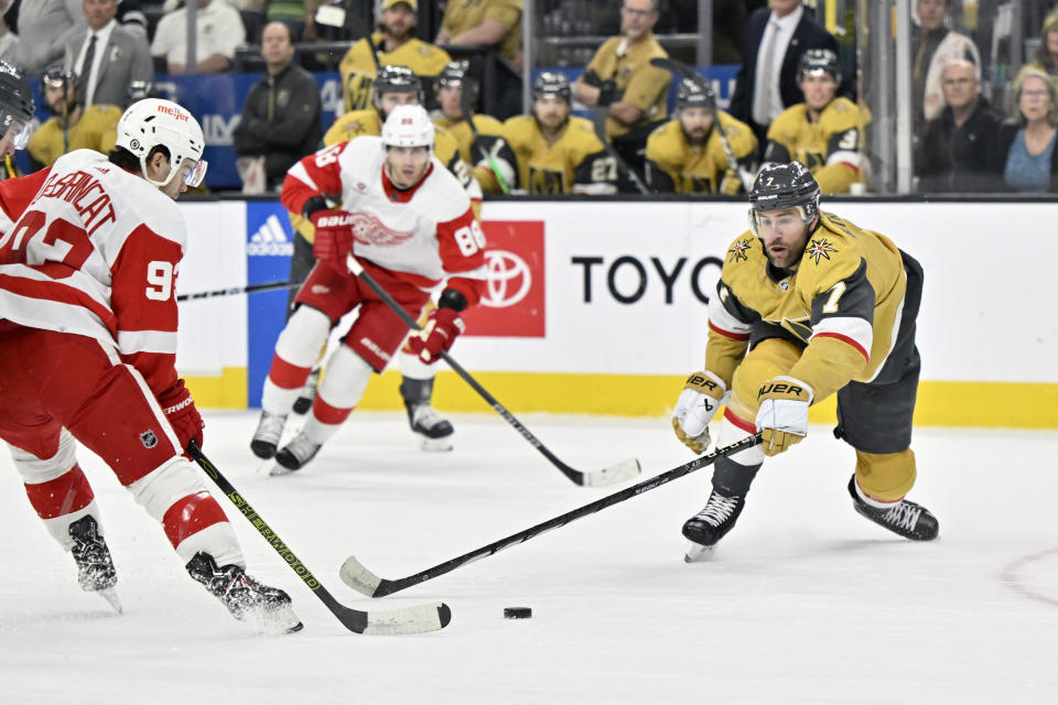 Vegas Golden Knights defenseman Alex Pietrangelo (7) and Detroit Red Wings right wing Alex DeBrincat (93) vie for the puck during the first period of an NHL hockey game Saturday, March 9, 2024, in Las Vegas. (AP Photo/David Becker)