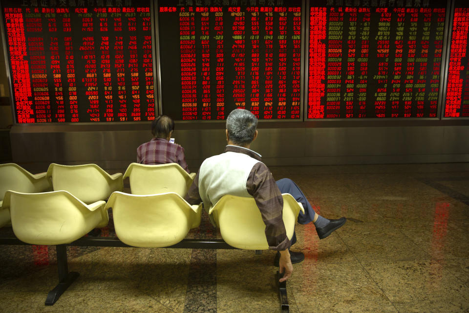 Chinese investors monitor stock prices at a brokerage house in Beijing Friday, Sept. 28, 2018. Asian markets rebounded on Friday as strong U.S. economic data supported the Federal Reserve's decision to raise interest rates. (AP Photo/Mark Schiefelbein)
