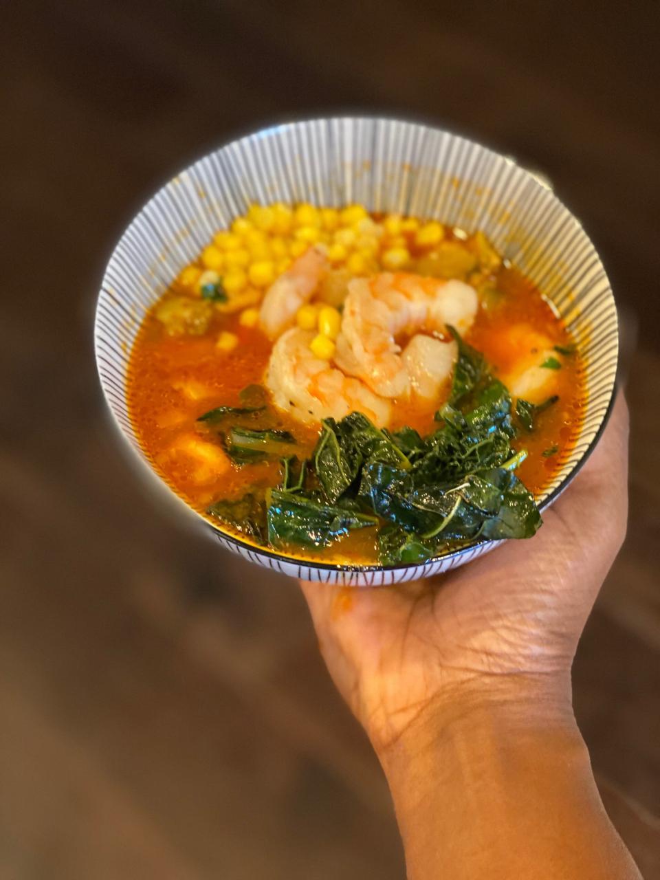 Homemade veggie soup with grilled shrimp and sautéed kale.