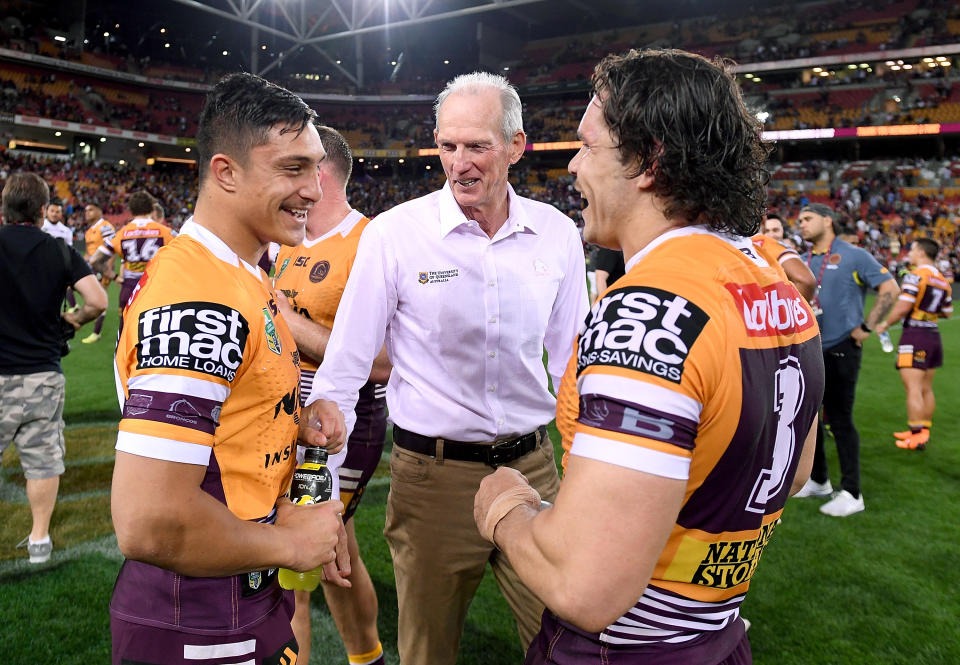 Wayne Bennett, pictured here chatting to Broncos players during his time in charge in 2018.