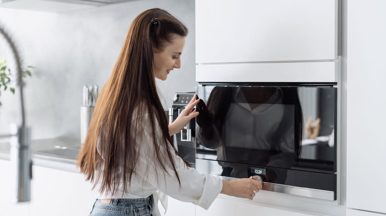 Woman using a microwave