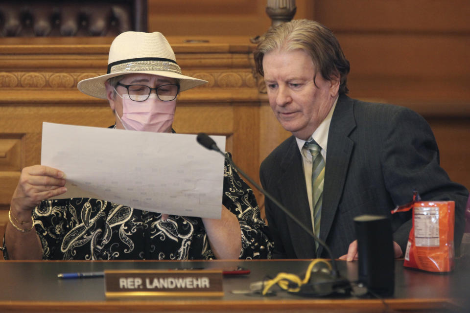 In this Jan. 18, 2022, photo, Kansas state Reps. Brenda Landwehr, left, R-Wichita, and Steve Huebert, R-Valley Center, confer during a meeting of a House committee on redistricting at the Statehouse in Topeka, Kan. Republicans are pushing a proposal to draw Democratic voters out of the swing Kansas City-area congressional district that's represented by the only Democrat from Kansas in Congress. (AP Photo/John Hanna)