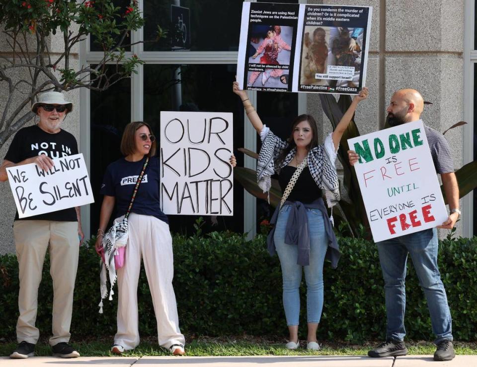 Protestors (Ken Barnes, left, Katherine Shehadeh, Sabren Najjar, and Jalal Shehadeh, right) stand outside the City of Doral Government Center in protest of any change to the current Israel-Palestine peace resolution passed in early May.