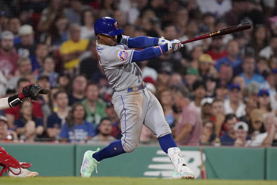 New York Mets' Francisco Lindor singles to left field, allowing Danny Mendick to score, in the sixth inning of a baseball game against the Boston Red Sox, Sunday, July 23, 2023, in Boston. (AP Photo/Steven Senne)