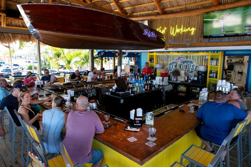 Patrons enjoy the re-opening of the Boathouse in Cape Coral Monday morning, July 10, 2023. The restaurant had been closed after suffering damage from the impact of Hurricane Ian last year. 