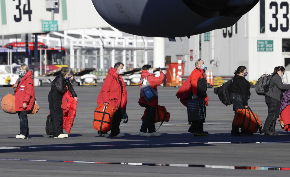 Staff board a U.S. Air Force C17 as they prepare to take the season's first flight to McMurdo Station in Antarctica from Christchurch Airport, New Zealand, Monday, Sept. 14, 2020. The first U.S. flight into Antarctica following months of winter darkness left from New Zealand Monday with crews extra vigilant about keeping out the coronavirus. (AP Photo/Mark Baker)