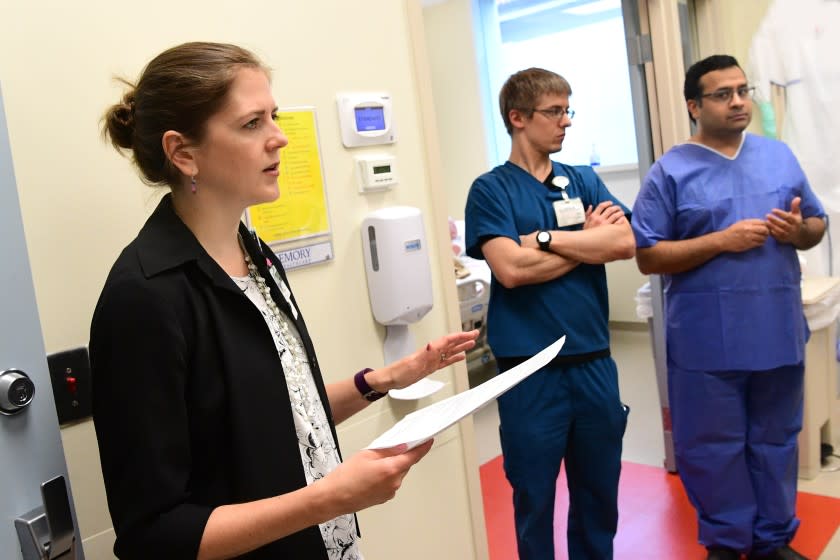 Dr. Colleen Kraft, left, is an infectious disease expert at Emory Hospital in Atlanta. She helped treat patients with Ebola, now she is facing off with the coronavirus.