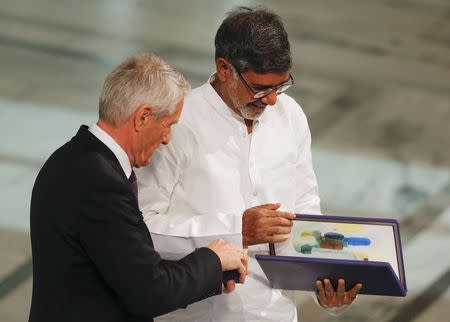 Nobel Peace Prize laureate Kailash Satyarthi receives the medal and the diploma during the Nobel Peace Prize awards ceremony at the City Hall in Oslo December 10, 2014. REUTERS/Suzanne Plunkett