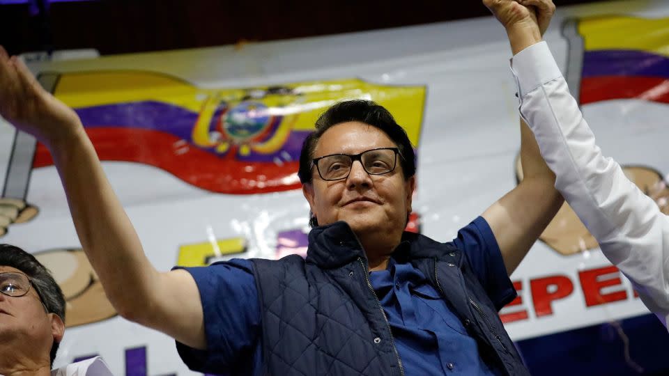 Ecuadorean presidential candidate Fernando Villavicencio waves an Ecuadorian flag as he attends a rally in Quito on August 9. - Karen Toro/Reuters