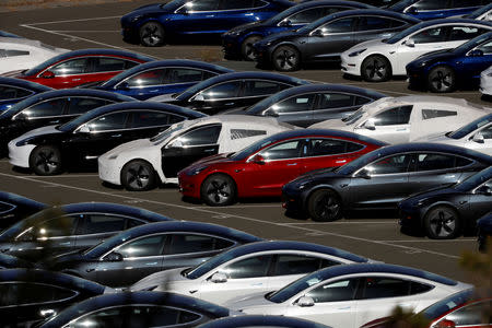 FILE PHOTO: Rows of the new Tesla Model 3 electric vehicles are seen in Richmond, California, U.S., June 22, 2018. REUTERS/Stephen Lam/File Photo