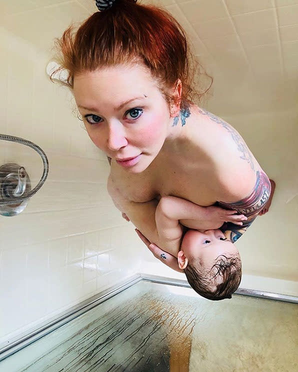 Jenna Jameson breastfeeds her daughter Batel in the shower