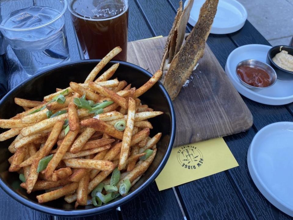 fries and a beer on a table at New Ridge Brewing