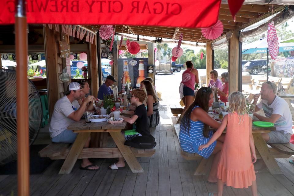 Families enjoy lunch at Paddy's Raw Bar in St. George Island on Saturday, Oct. 12, 2019. 