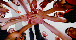 The cast of "Glee" having a hands in moment before a performance