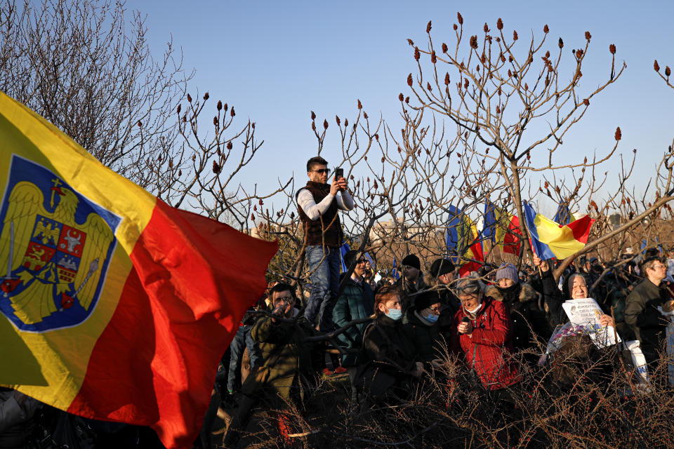 Anti-vaccination protesters rally outside the parliament building in Bucharest, Romania, Sunday, March 7, 2021. Some thousands of anti-vaccination protestors from across Romania converged outside the parliament building protesting against government pandemic control measures as authorities announced new restrictions amid a rise of COVID-19 infections. (AP Photo/Vadim Ghirda)