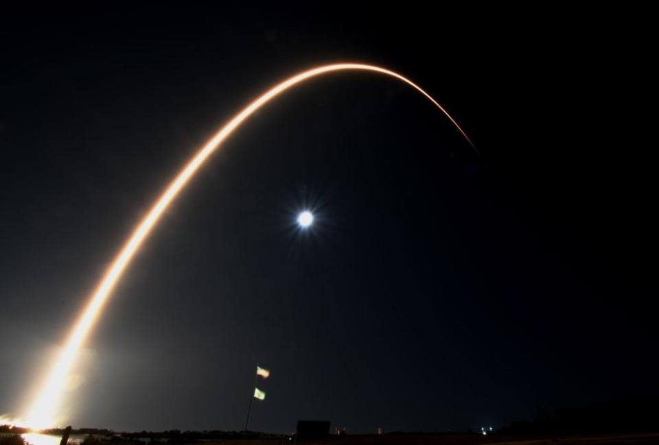 A time exposure captures the launch of a SpaceX Falcon 9 rocket over a full moon Tuesday as it climbed away from historic pad 39A at the Kennedy Space Center. It was SpaceX's 121st Florida launch, but only the sixth taking off on a southeasterly trajectory. / Credit: William Harwood/CBS News