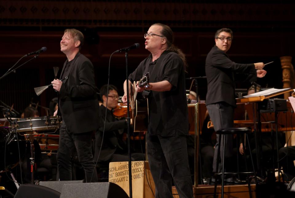 John Sparrow and Gordon Gano of the Violent Femmes perform as Ryan Tani conducts the Milwaukee Symphony Orchestra at a sold-out Bradley Symphony Center Tuesday. It was the first show of a fall tour celebrating the 40th anniversary of the Milwaukee band's debut album.