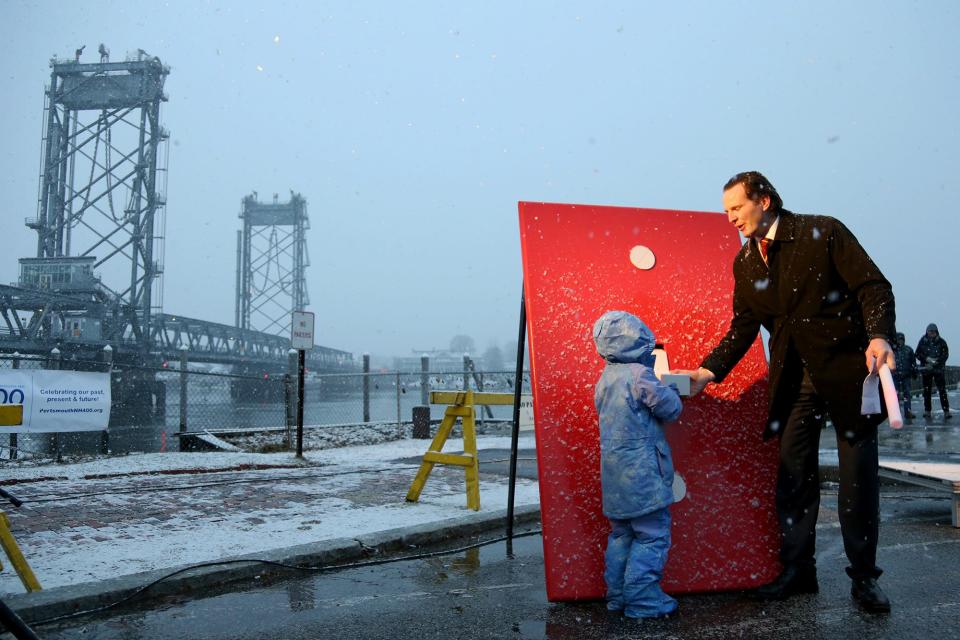 Portsmouth Mayor McEachern and his daughter, Tiernan, flip the switch on the lights of Memorial Bridge during Portsmouth's 400th annniversary kickoff event Friday, Jan. 6, 2023 at Prescott Park.