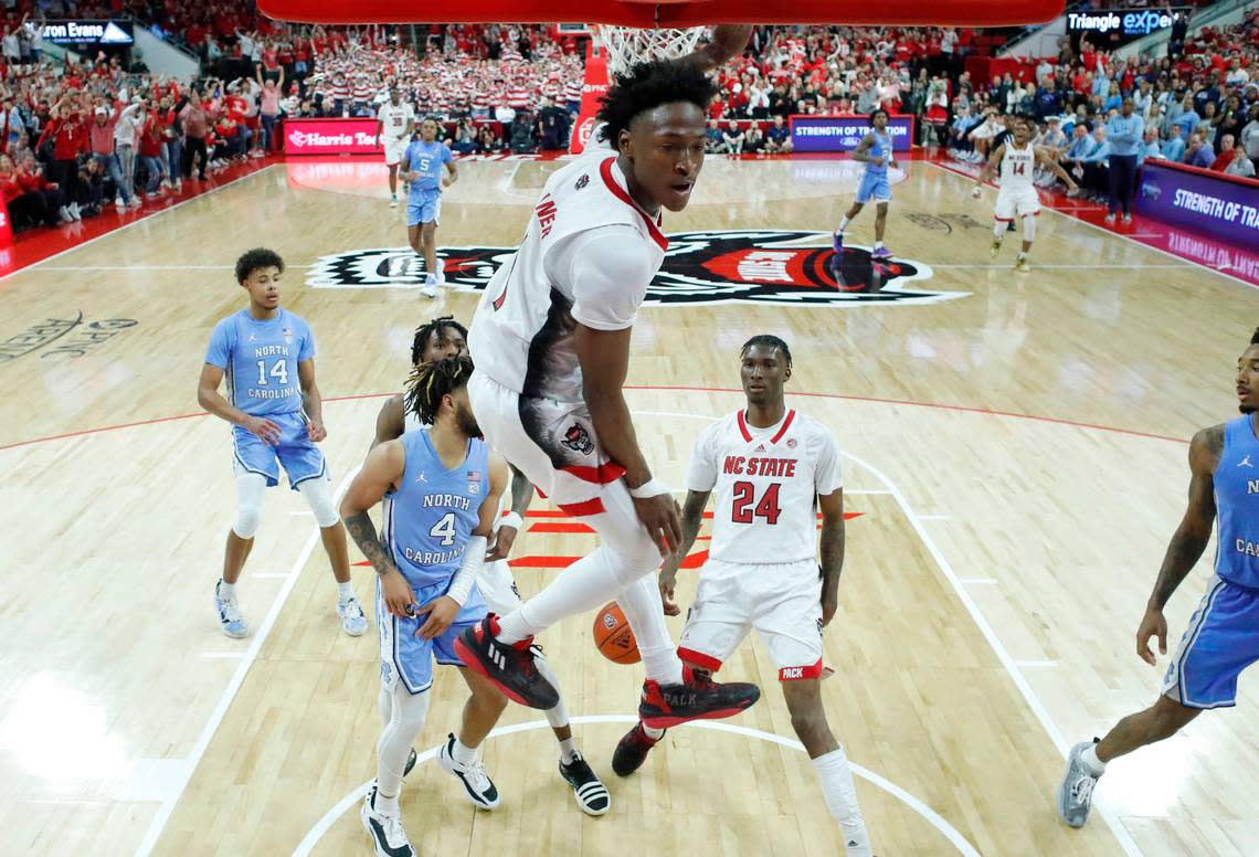 N.C. State’s Jarkel Joiner (1) comes down after slamming in two on an alley-oop from Terquavion Smith (0) during N.C. State’s 77-69 victory over UNC at PNC Arena in Raleigh, N.C., Sunday, Feb. 19, 2023.