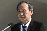 Japan's Prime Minister Yoshihide Suga delivers a speech during a ceremony at the Hiroshima Peace Memorial Park in Hiroshima, western Japan Friday, Aug. 6, 2021. Hiroshima on Friday marked the 76th anniversary of the world's first atomic bombing of the city. (Kyodo News via AP)