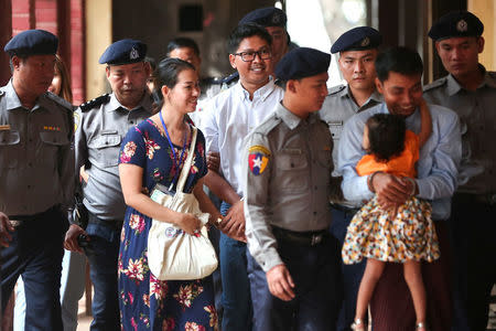 Detained Reuters journalists Wa Lone and Kyaw Soe Oo are escorted by police as they arrive for a court hearing in Yangon, Myanmar, February 21, 2018. REUTERS/Stringer