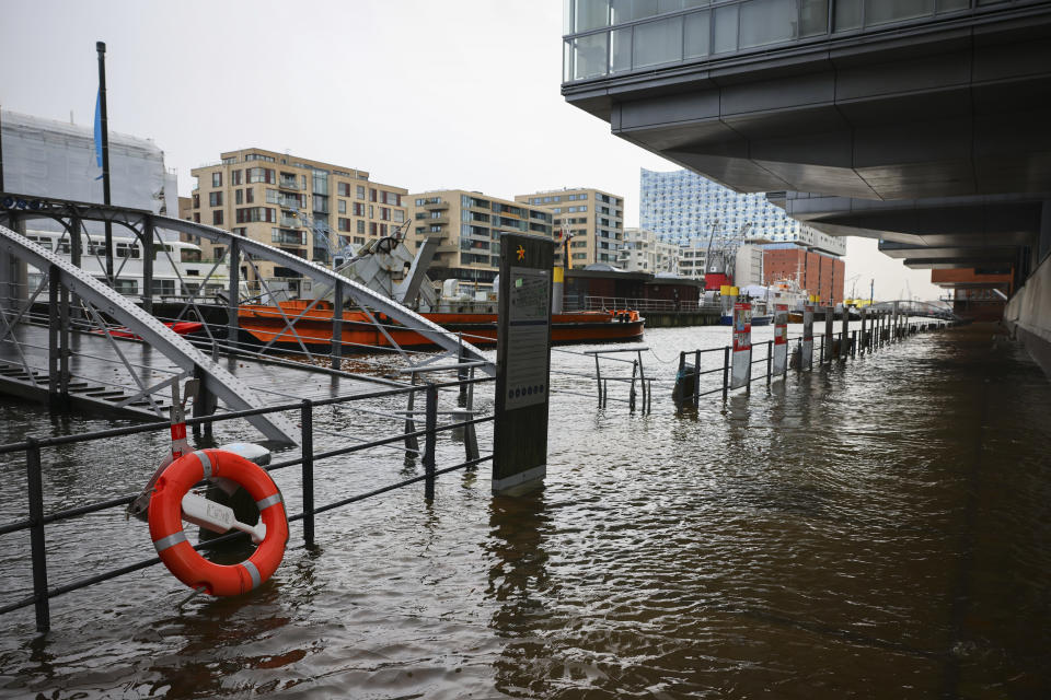 The flooded promenade at the traditional ship harbor in Hafencity, Hamburg, Germany, Friday Dec. 22, 2023. There is a risk of a severe storm surge for the German North Sea coast and Hamburg on Friday. (Christian Charisius/dpa via AP)