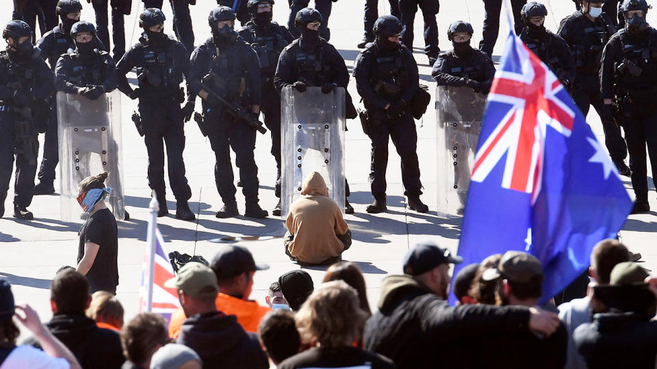 Police, pictured here standing guard as demonstrators protest on the steps of the Shrine of Remembrance.