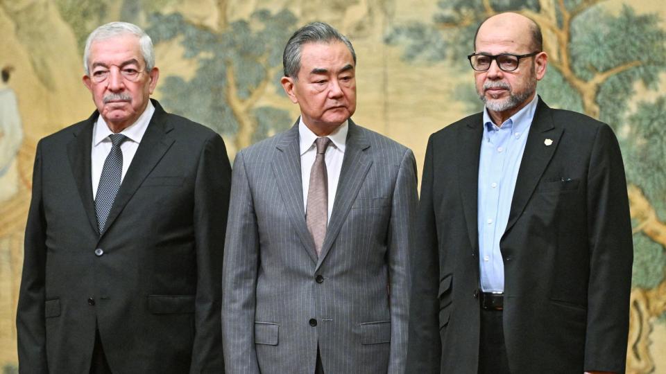  Mahmoud al-Aloul, Vice Chairman of the Central Committee of Palestinian organisation and political party Fatah, China's Foreign Minister Wang Yi, and Mussa Abu Marzuk, senior member of Hamas. 