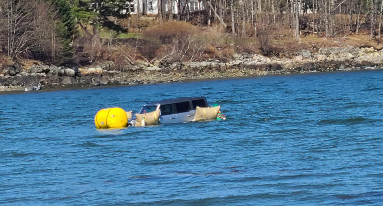 Car floating in water with airbags attached