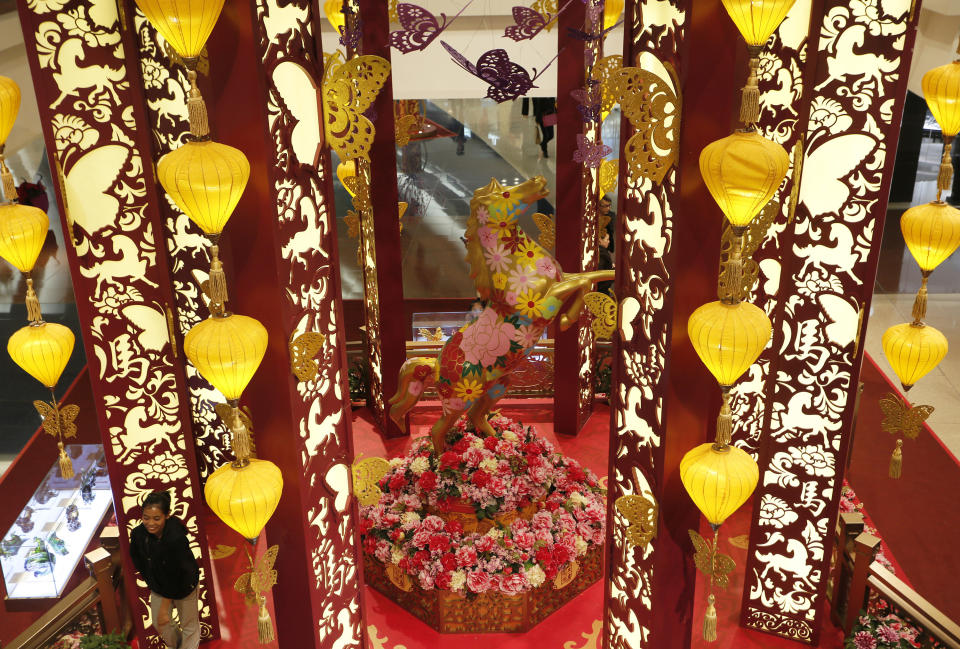 In this Tuesday, Jan. 28, 2014 photo, Chinese New Year decorations with a golden horse are displayed at a shopping mall in Hong Kong. Chinese communities around the world were welcoming the arrival of the year of the horse on Friday, Jan. 31 with equine-themed decorations and celebrations. The annual Lunar New Year holiday is mark with particular verve in Hong Kong, the semi-autonomous Chinese financial center that expects 7.93 million visitors, more than territory’s permanent population of 7.1 million. (AP Photo/Vincent Yu)