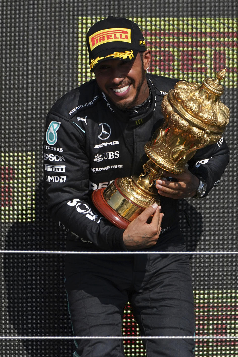 Mercedes driver Lewis Hamilton of Britain celebrates on the podium after winning the British Formula One Grand Prix, at the Silverstone circuit, in Silverstone, England, Sunday, July 18, 2021. (AP Photo/Jon Super)