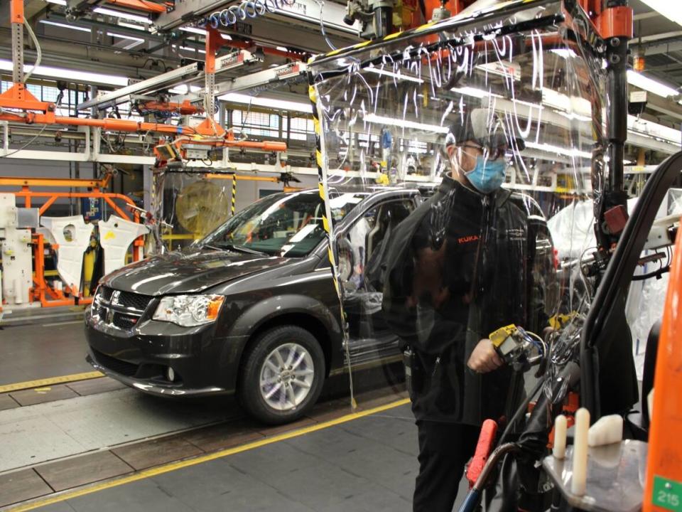 An employee working on the assembly line with added safety precautions at the Stellantis Windsor Assembly Plant. The company says COVID-19 vaccinations will be mandatory for employees as of Dec. 17. (Submitted by FCA - image credit)