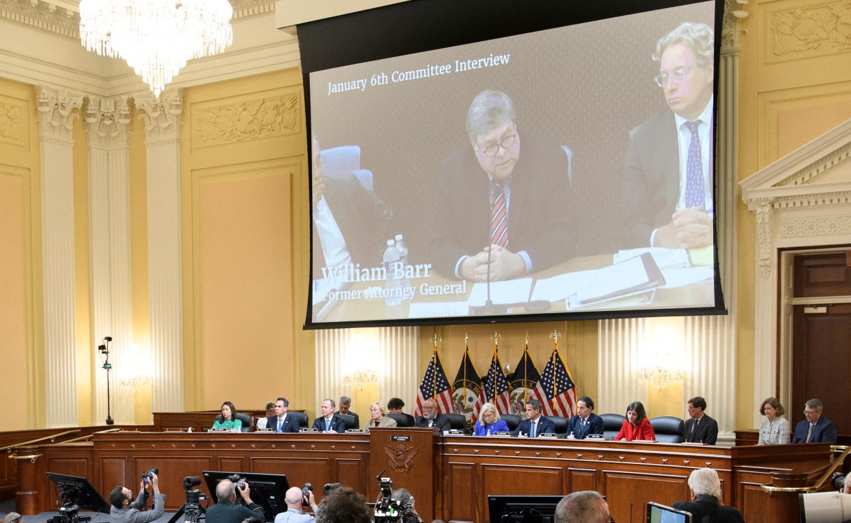 A video image of Attorney General Bill Barr is seen on a screen, with the House select committee seated below it. 