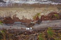 <p>A car drives on a damaged road in the aftermath of Hurricane Maria in Humacao, Puerto Rico on Oct. 2, 2017. (Photo: Ricardo Arduengo/AFP/Getty Images) </p>