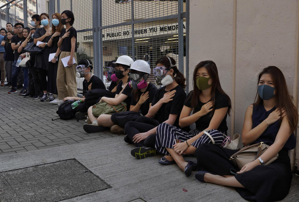 Supporters wearing masks attend a strike in Hong Kong, Wednesday, Oct. 2, 2019. Hundreds of students at a Hong Kong college have staged a strike to condemn police shooting of a teenager during widespread violence in the semi-autonomous Chinese territory at pre-democracy protests that marred China's National Day. (AP Photo/Vincent Yu)