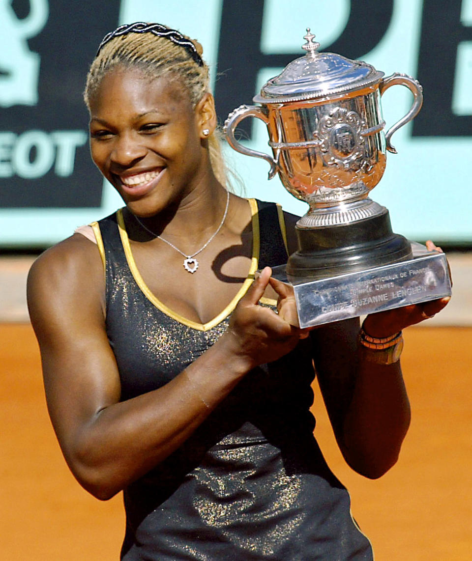 Serena Williams holds the Roland Garros French Open trophy, 08 June 2002 in Paris, at the end of the Roland Garros French Open women's final match against her sister and opponent Venus Williams. Serena won 7-5, 6-3. (Photo by Andre Durand/AFP/Getty Images)