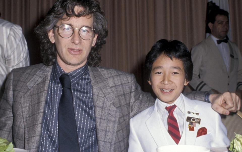 Ke Huy Quan with Steven Spielberg in 1985 - Getty