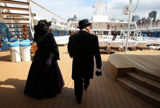 Passengers wear period clothing as they stand on the deck of the Azamara Journey on April 10 in New York City. Titanic fans aboard cruise ships are journeying to the spot where the great liner hit an iceberg exactly 100 years ago on Sunday, as somber ceremonies were held on land to mark the disaster