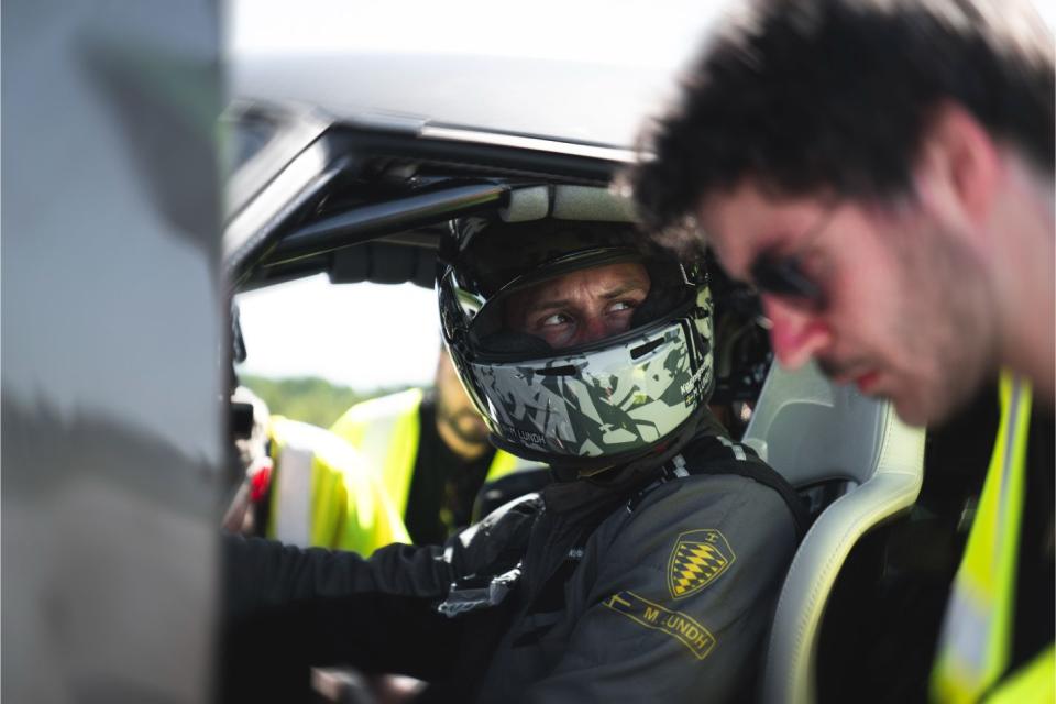 a man in a helmet and goggles looking at another man