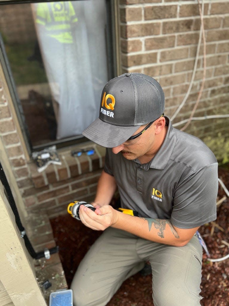 Ryan Fallon, a technical operations supervisor with IQ Fiber, hooks up a customer's home to the company's fiber optics network. IQ Fiber recently announced it would expand its coverage area around Jacksonville.