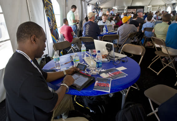 Actor and Producer Levar Burton tweets with two devices during the STS-134 Tweetup, Thursday, April 28, 2011, at Kennedy Space Center in Cape Canaveral, Fla. About 150 NASA Twitter followers attended the event.