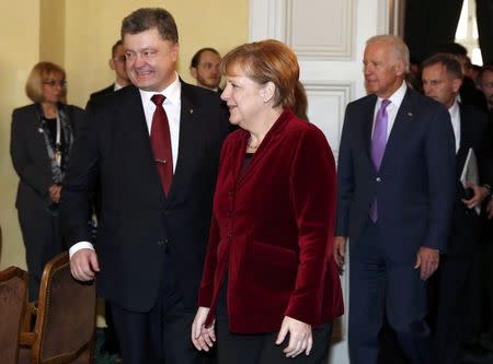 Ukraine's President Petro Poroshenko, German Chancellor Angela Merkel and U.S. Vice President Joe Biden (L-R) arrive for a meeting during the 51st Munich Security Conference at the 'Bayerischer Hof' hotel in Munich February 7, 2015. REUTERS/Michaela Rehle