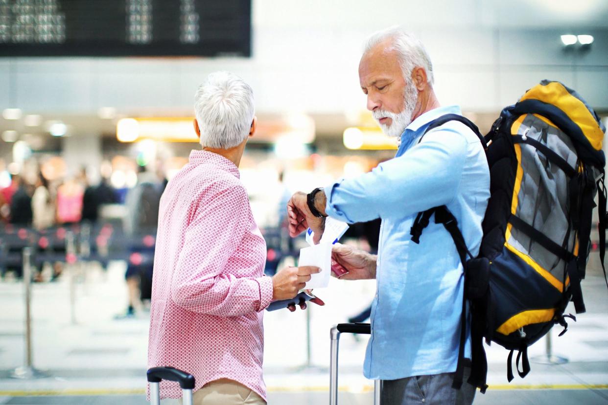 retirees at airport checking flight time