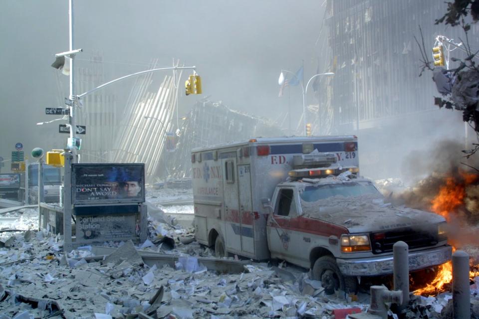 An ambulance, covered with debris and on fire, after the collapse of the first tower (AFP/Getty)