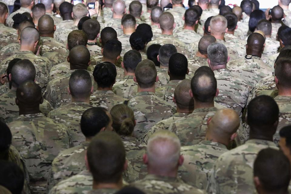 U.S. troops based in Afghanistan listen to remarks during a surprise visit by U.S. President Barack Obama (not pictured) at Bagram Air Base in Kabul, May 25, 2014. Obama made a surprise trip to Afghanistan on Sunday to visit U.S. forces who are wrapping up a 13-year mission and signaled that he intends to keep a small number of troops in the country for training and counter-terrorism operations. The unannounced Memorial Day visit is Obama's first with U.S. troops in Afghanistan since 2012. (REUTERS/Jonathan Ernst)